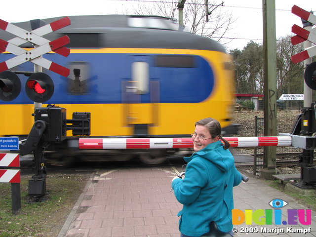 SX02867 Jenni on Machteld's bike waiting for train on level crossing